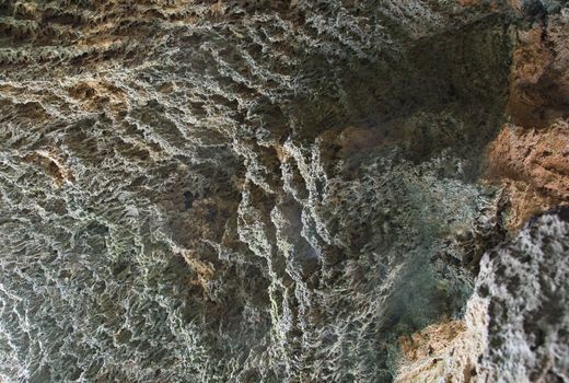 Walls of a cave under a small waterfall in Crimea