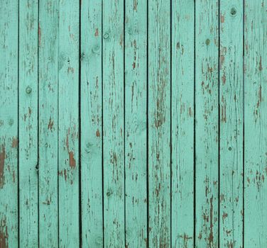 Close up of old green wooden fence panels