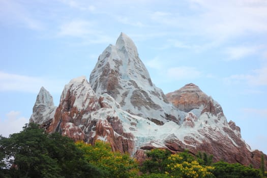 A large rocky mountain covered in snow.