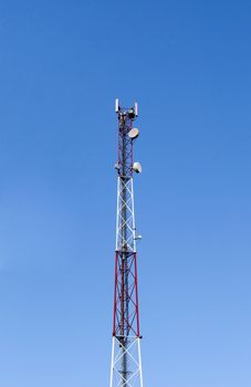 Top of a cellular tower on blue sky background