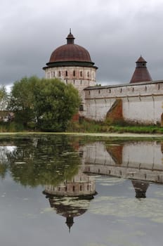 Tower of ancient russian Monastery of Sts Boris and Gleb near Rostov the Great, reflected in a pond