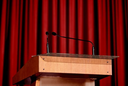 microphone on the podium with red curtain background