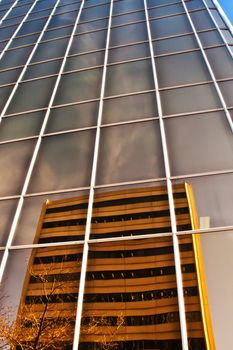 a city building with mirror-like reflections of the neighbouring building