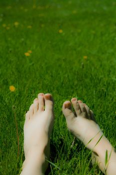 a woman's feet on the grass