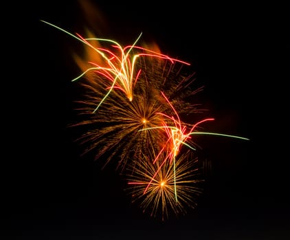 Fireworks display that is centered showing exploding fireworks plus streams. Image is isolated against black making it easy to add copyspace in any direction so you can add your own text.