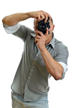 Man taking pictures with retro camera. Isolated on white.