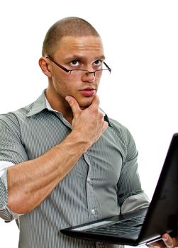 Young man wih laptop thinking. Isolated on white background.