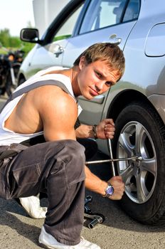 Mechanic fixing a tire on a road