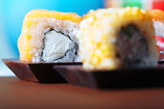 Macro photo of the rolled sushi with Philadelphia cheese and rice. Horizontal. Shallow depth of field
