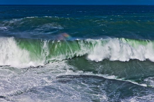 Dramatic seascape showing the detail of a breaking wave on a bright day