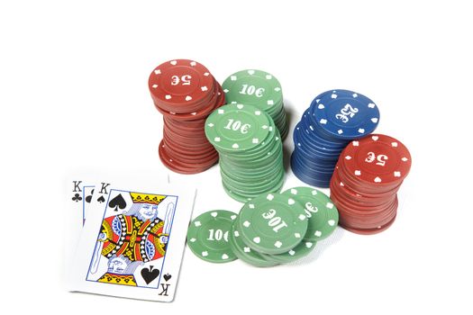 Pair of kings and poker chips on a white table