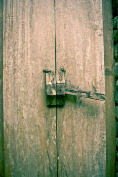 Close-up of an old wooden door with an iron lock.