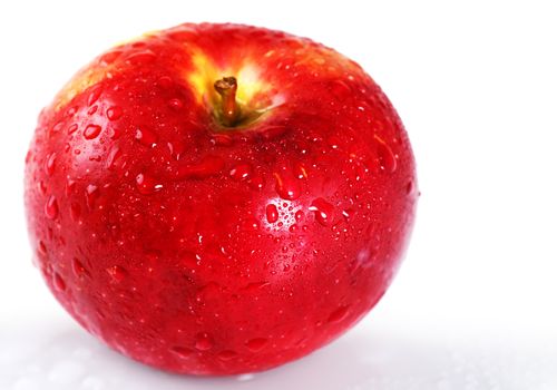 Beautiful studio shot of a fresh and wet red apple with water droplets dripping off it over white, perfect nutrition or diet background.