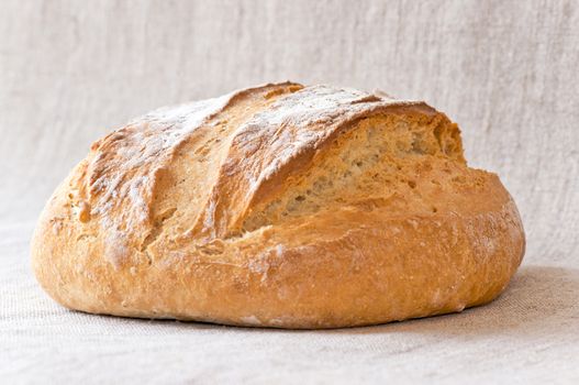 Honey white bread with poolish on canvas background close up