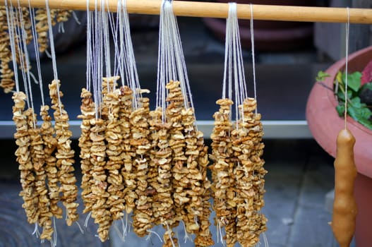 Walnuts rows for georgian traditional dish - churchkhela on the street of Tbilisi