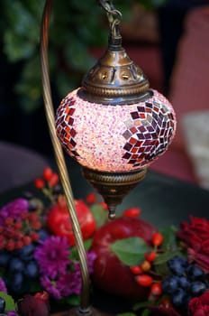 Closeup of mosaic lamp in arabic style with autumn fruits and vegetables