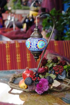 Closeup of mosaic lamp in arabic style with autumn fruits and vegetables