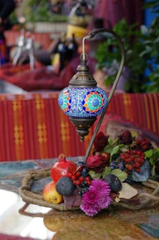 Closeup of mosaic lamp in arabic style with autumn fruits and vegetables