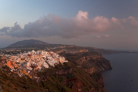 Thira and Santorini island view in beams of sunset