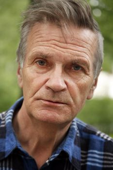 Portrait of the elderly tired man