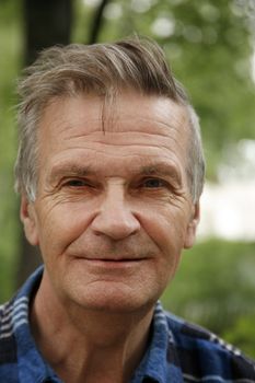 Portrait of the elderly tired man