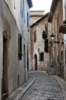 Narrow medieval street in Old Sigest town, historical resort-city close to Barcelona city, Spain