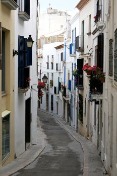Narrow medieval street in Old Sigest town, historical resort-city close to Barcelona city, Spain