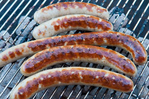 Grilled traditional German sausage hot dog on charcoal wurst BBQ grill