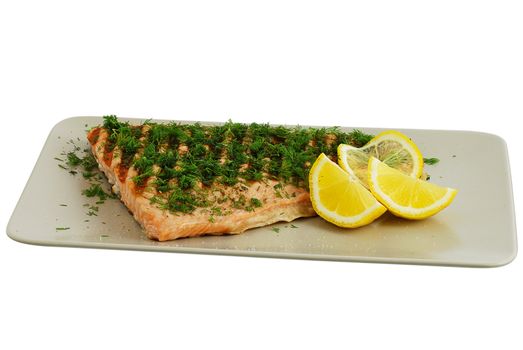 Grilled salmon fish fillet with dill and lemon on grey ceramic dish isolated on white background