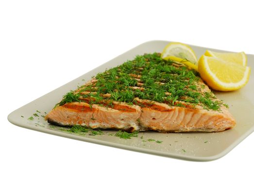 Salmon fish fillet grilled with green vegetables and lemon isolated on white background