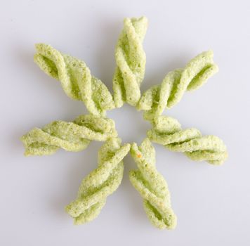 Junk food, green peas snack on a background