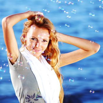 happy blond hair woman sea on background