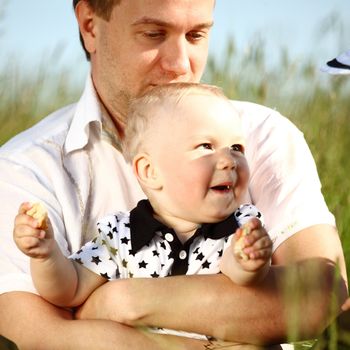 father and son in green grass