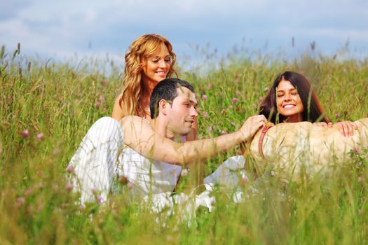 friends and dog in green grass field