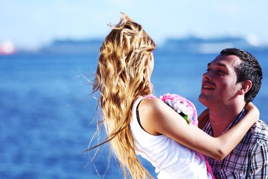 man and woman hug in the sky and sea on sea