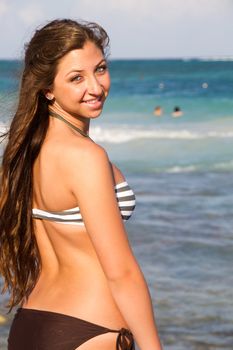Young beautiful women in a Bikini on the sunny tropical beach