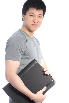 Casual young Asian man holding a black binder and smiling isolated on white background