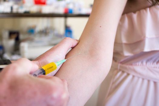 Woman getting a vaccination in the arm