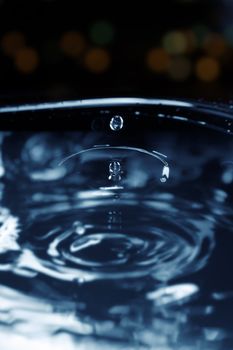 Liquid drop falling. Extremelly close-up photo with shallow depth of field