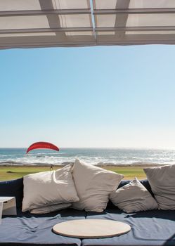 Beach club couch with ocean in the background