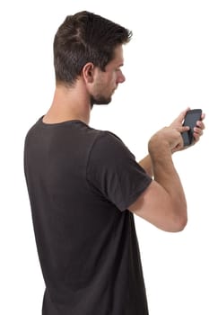 Young White Man In Black T-Shirt Working On His Smartphone