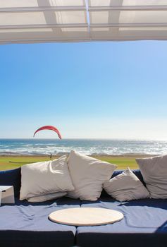 Beach club couch with ocean in the background