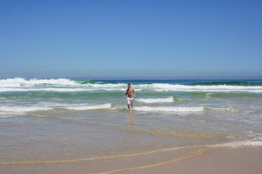 Man running out of indian ocean in south africa