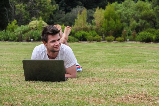 Man working on Notebook outdoors in park