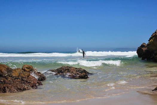 Surfers at the indian ocean at Paddat se gat beach in cape town, south africa