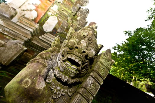 Balinese stone sculpture of a deity at temple