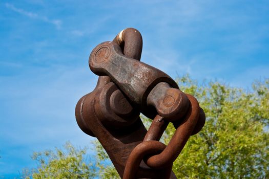 big old rusted anchor chain knot againdt blue sky
