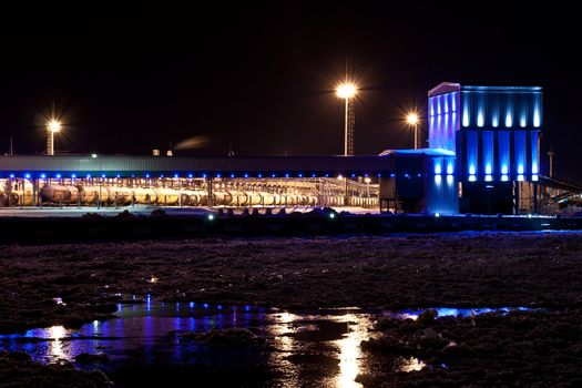 Port ammonia complex with a frozen river front in the winter night