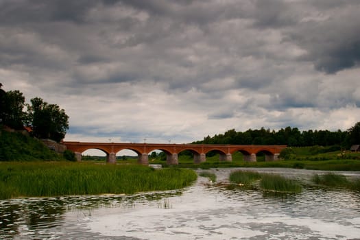 old red brick bridge and dark skies