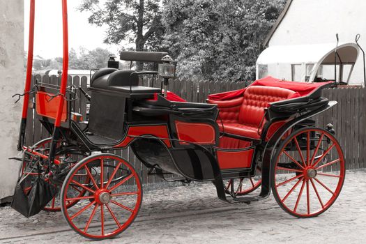 Old red coupe at the edge of the city's streets